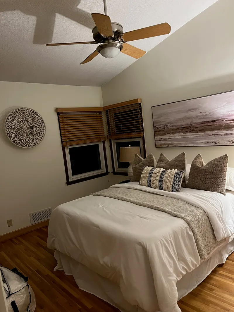 Cozy bedroom with warm neutral paint tones and vaulted ceiling